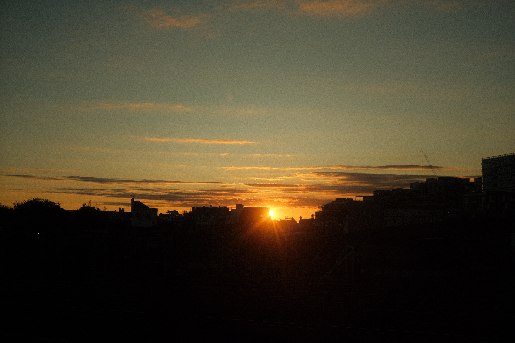 Sunset over cityscape representing successful transitions